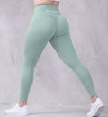 Mila high-waisted yoga leggings in Pista Green, shown on model